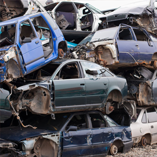 Old junk cars and trucks in a salvage yard